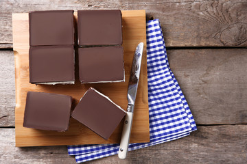Delicious chocolate brownies on wooden background