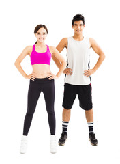 young fitness couple standing together isolated on white