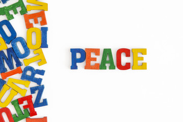 Series "Conceptual words": word "Peace" in wooden letters on white background
