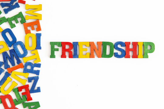 Series "Conceptual words": word "Friendship" in wooden letters on white background
