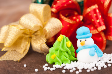 Christmas Decoration, snowman and ribbons on wooden background