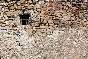old stone wall with window