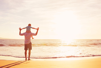 Father and Son Playing on the Beach at Sunset