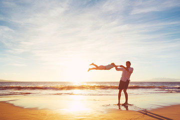 Father and Son Playing on the Beach at Sunset