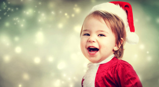 Toddler girl with a Santa hat