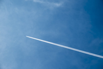 Jet airplane with trail of fuel