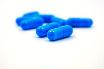 blue capsules on a white background