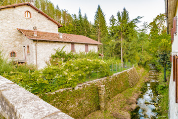 Fototapeta na wymiar stream through mountain village in Tuscany