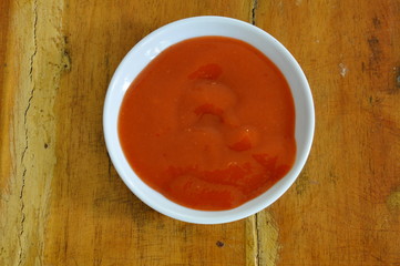 chili sauce in little cup on table