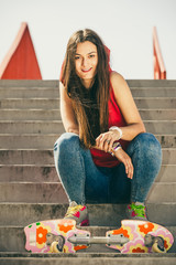 Skate girl on stairs with skateboard.