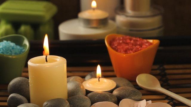 Spa composition with sea salt, candles, soap, shells, creams for face on wooden background. Aromatherapy.