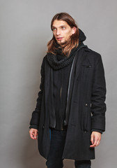 Handsome fashion man portrait wearing black coat.