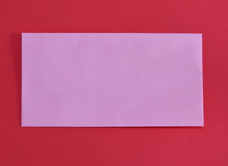 pink envelope on red color foam board
