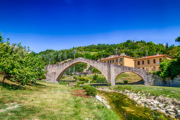 Fototapeta na wymiar three archs medieval bridge in Italy