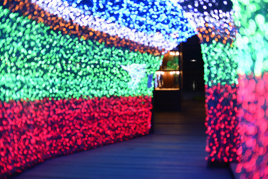 De-focused Christmas Light-colored walkway tunnel.