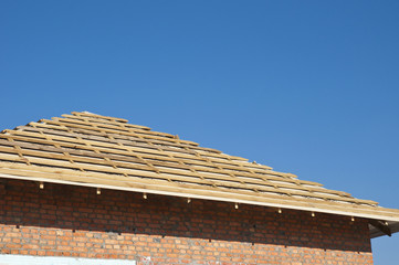 New Roof Membrane Coverings Wooden Construction Home Framing with Roof Rafters Outdoor Against a...