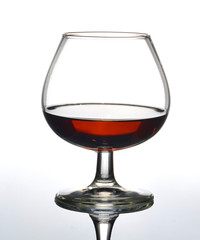 Glass of cognac on on white background