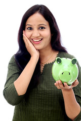 Young Woman Saves Money in Piggy bank