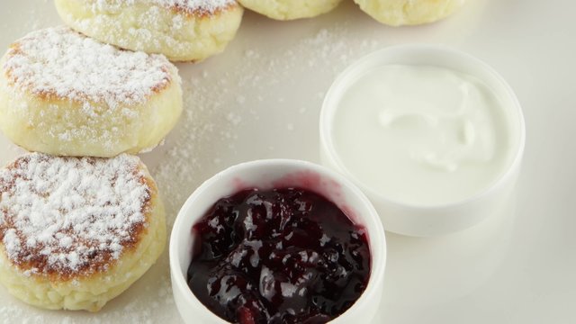 cheese pancakes with sour cream and jam