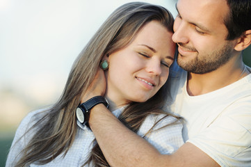 Fototapeta na wymiar portrait of tender sensual young couple in love posing on sunset