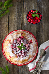 cranberry cake decorated with powdered sugar and fresh berries f