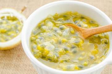 Passion fruit juice with wooden spoon.