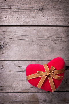 Decorative  red heart on  vintage wooden  background.