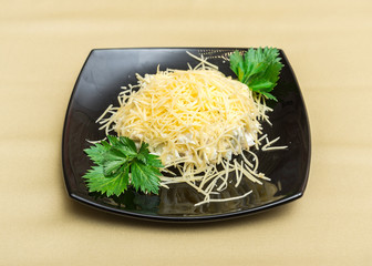 Cheese parsley salad on black plate