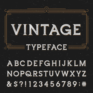 Vintage vector typeface. Type letters, numbers and symbols on a dark distressed background. Alphabet font for labels, headlines, posters etc.