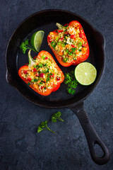  peppers staffed with coucous and vegetables on cast iron pan