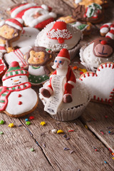 Christmas cupcakes and gingerbread closeup on a wooden table. vertical
