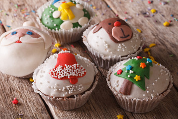 Beautiful festive cupcakes with Christmas decorations close-up 
