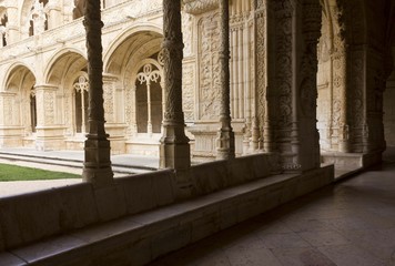 Hallway of Jeronimos Monastery in Lisbon, facing the arched doorways of the inner Cloister