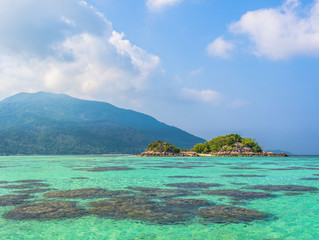 Fototapeta na wymiar Small island in tropical sea with blue sky