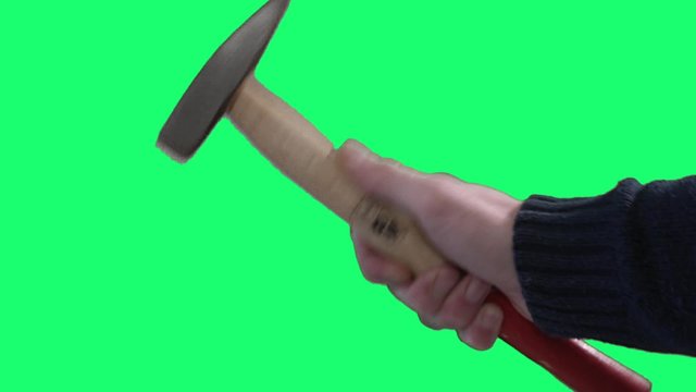 Hammering on green screen male hand - 60fps. Close shot of a hand hammering on a green screen background.