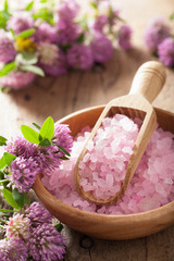 Obraz na płótnie Canvas spa with pink herbal salt and clover flowers