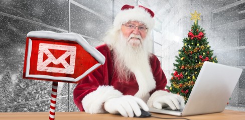 Composite image of santa surfs on the internet