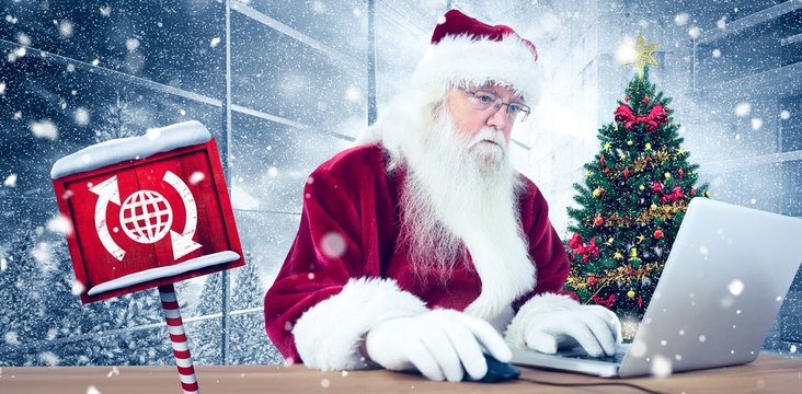 Composite image of santa surfs on the internet