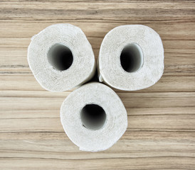 Toilet paper on the wooden background