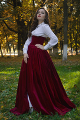 Woman dressed in a retro-style on the autumn alley