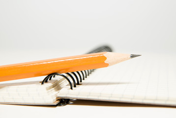 Opened notebook and pencil on over white