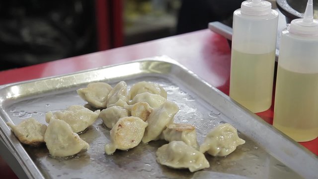 Cocinero preparando Gyoza, empanadillas tailandesas

