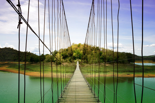 Fototapeta Wood rope bridge across the river  thailand