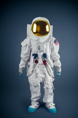 Astronaut standing on a grey background © fergregory