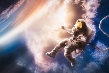 Fototapeta na wymiar Astronaut floating in the atmosphere