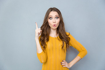 Charming woman pointing finger up