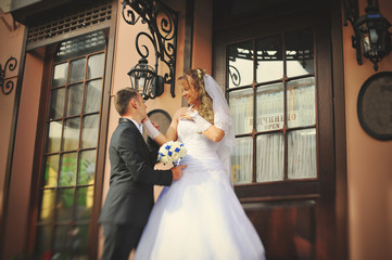 Fototapeta premium Happy wedding couple walking streets of city
