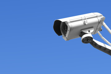Security camera on blue sky background