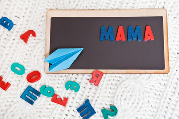 Magnetic Board with the word mom, which is lined with colored letters