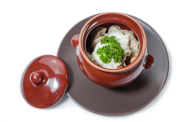 Meat dumplings and mushrooms with sour cream and herbs